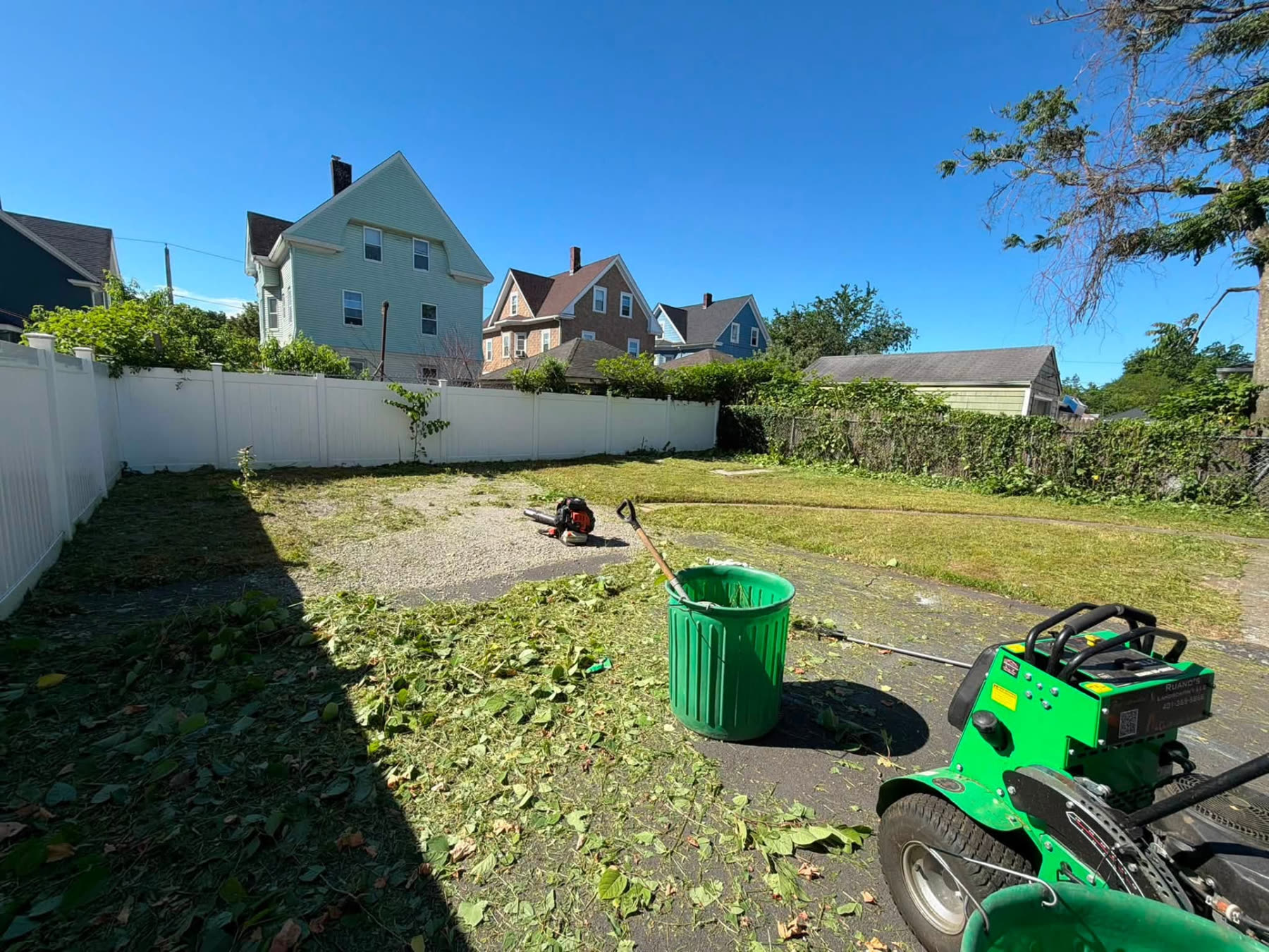 Ruano's Landscaping crew clearing and cleaning up a Rhode Island backyard